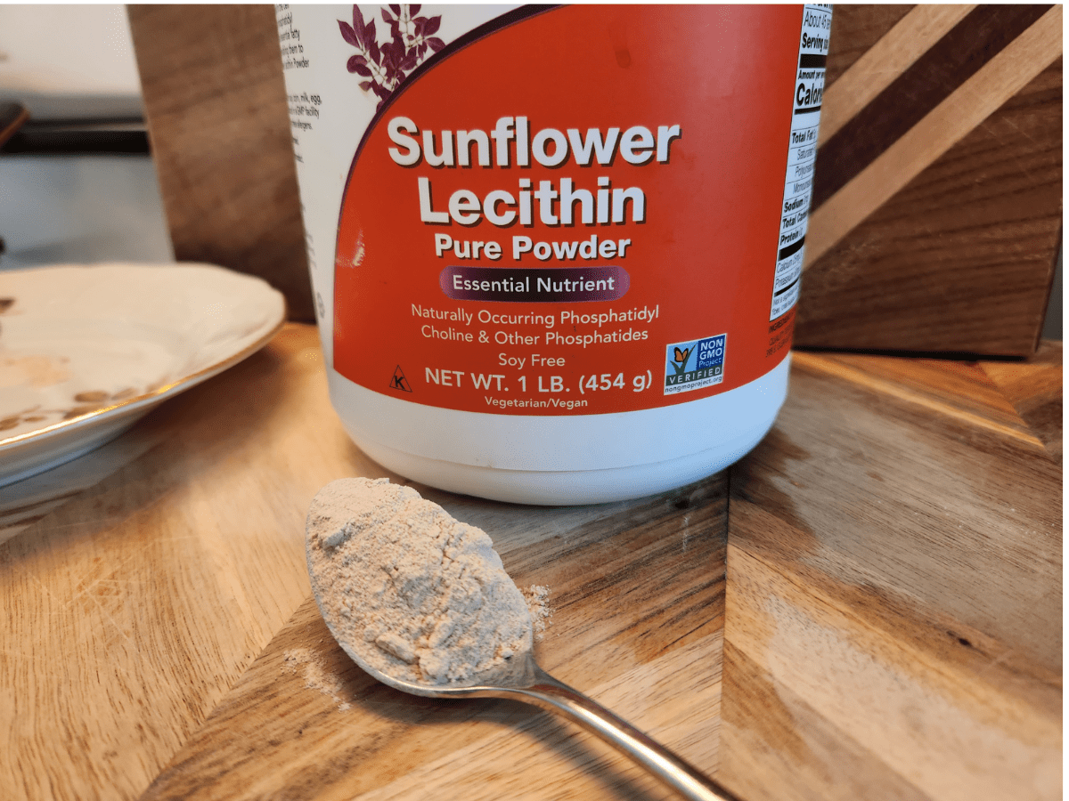 tub of sunflower lecithin and spoon with the powder in it 