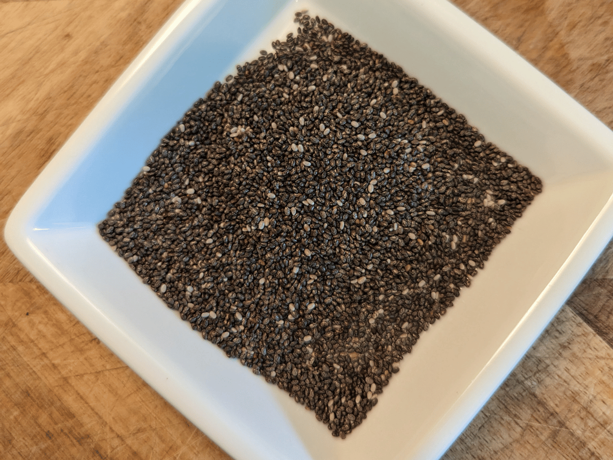 a white dish with dry chia seeds
