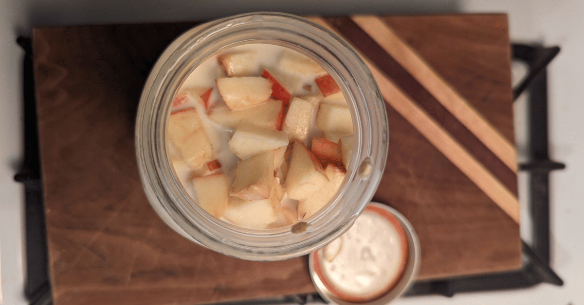 top of mason jar with apple slices on top of muesli