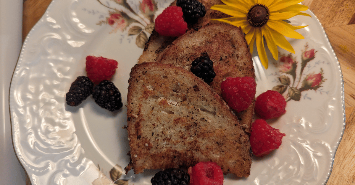 three slices of vegan french toast on a plate with a few berries